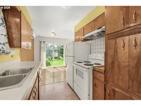 a kitchen with a sink stove and refrigerator