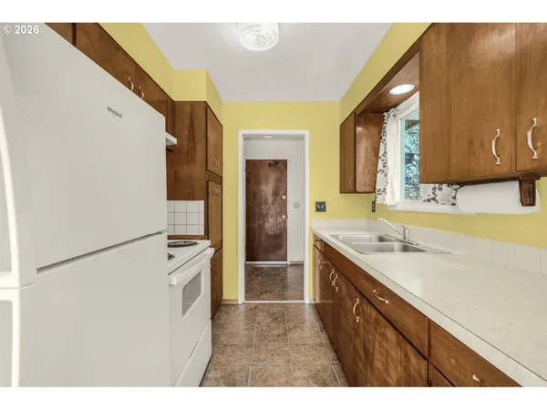 a kitchen with a sink appliances and cabinets