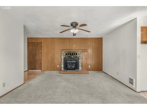 a view of an empty room with a fireplace