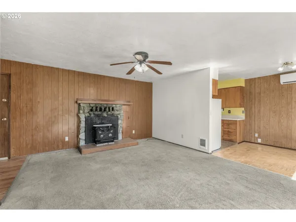 a view of an empty room with a fireplace
