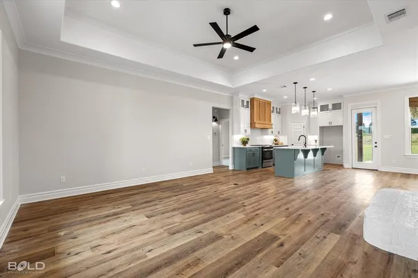 a large kitchen with a wooden floor and outdoor space