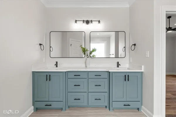 a bathroom with a double vanity sink a mirror and a toilet