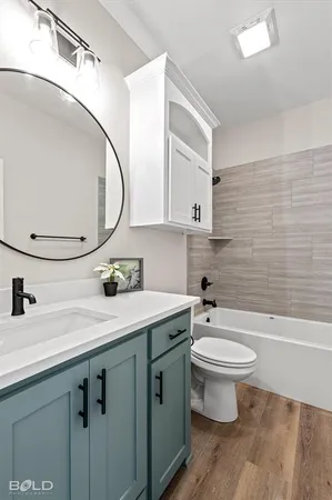 a view of a kitchen with wooden floor and cabinets
