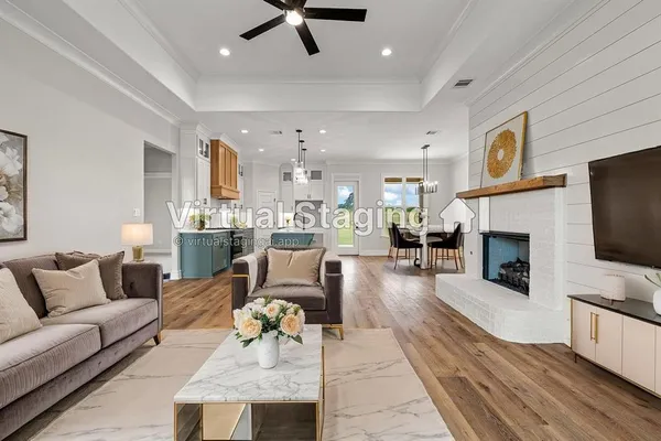 a living room with furniture a fireplace and a flat screen tv