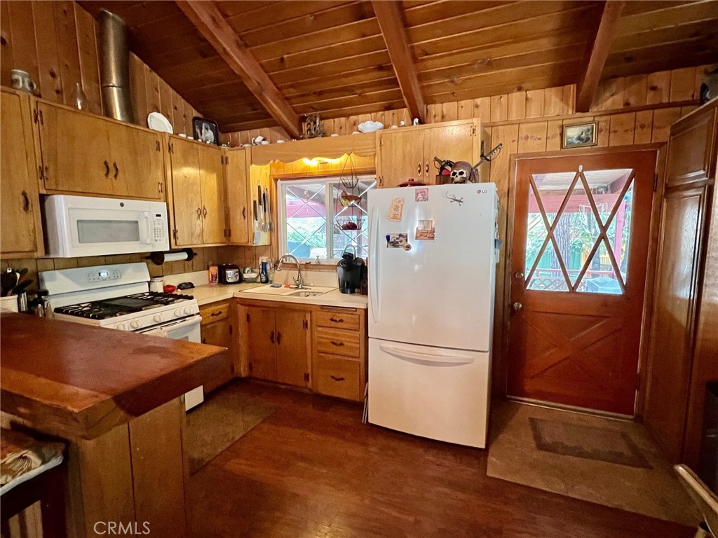 2551 Spring Drive Running Springs, CA 92382 - Photo 7 of 15 a kitchen with a refrigerator a stove a sink and a microwave