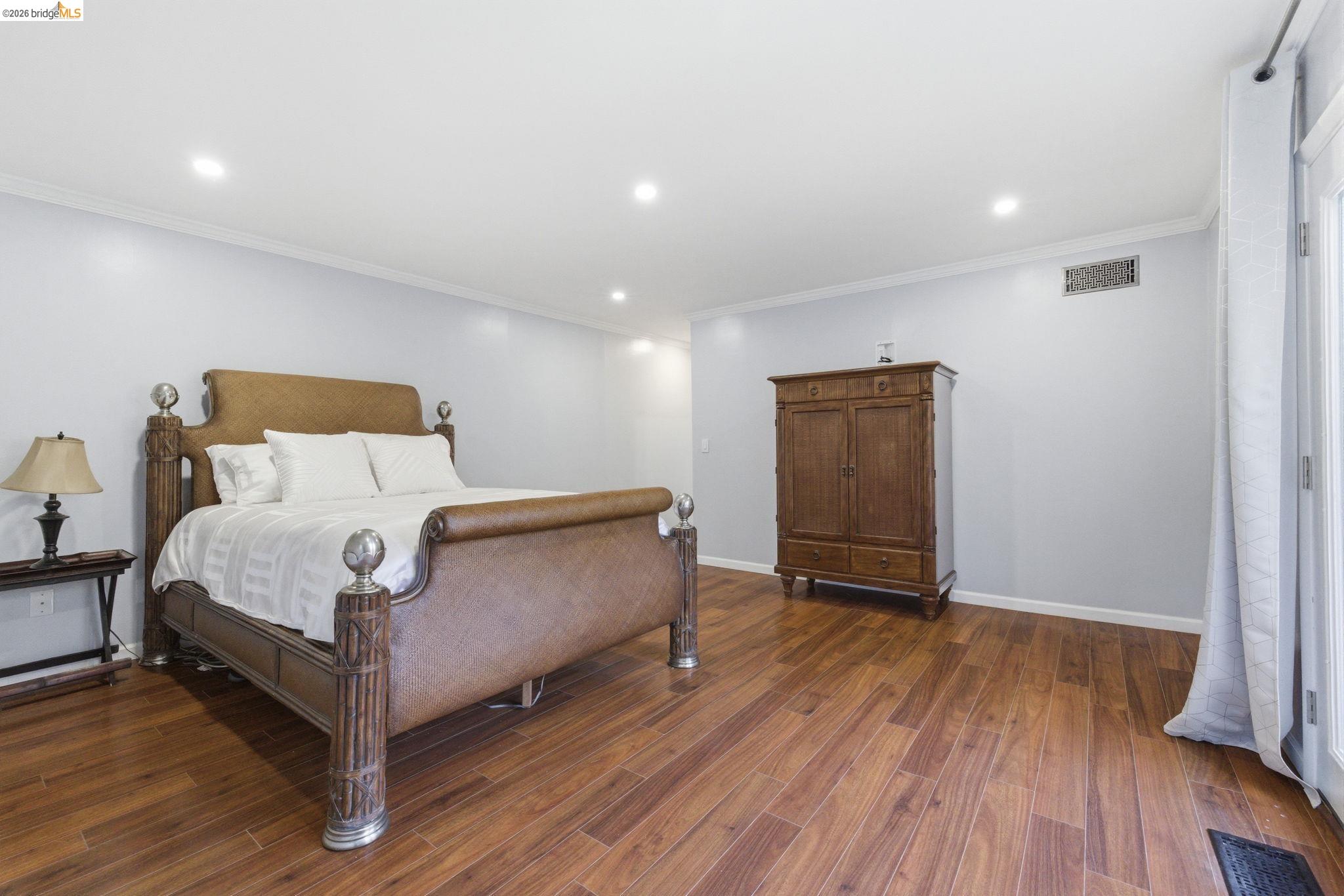 18389 Woodham Carne Road Sonora, CA 95370 - Photo 11 of 29 Bedroom with dark wood finished floors, crown molding, and recessed lighting