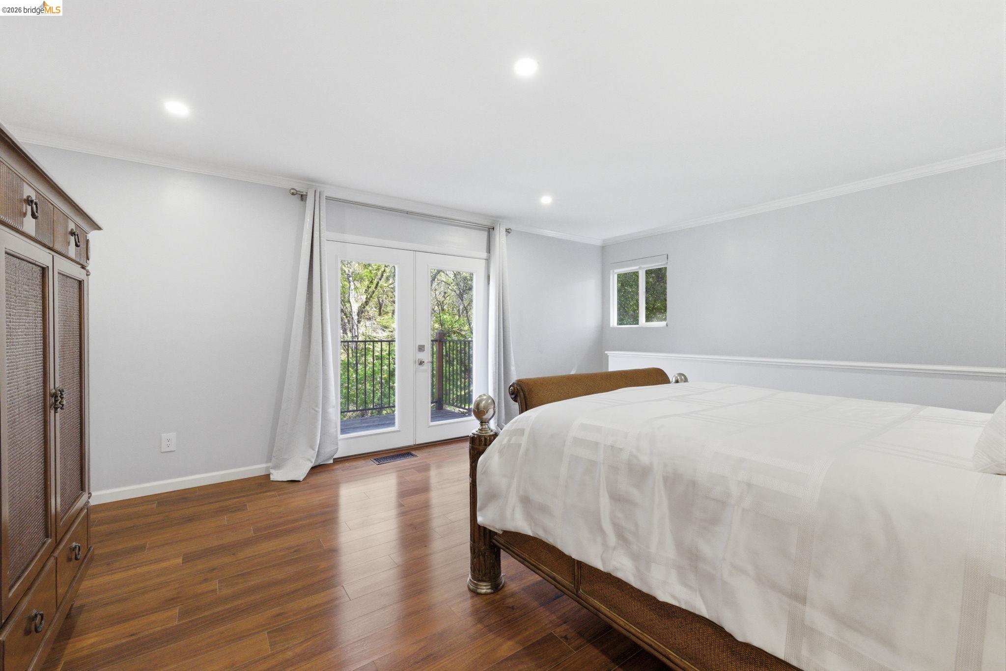 18389 Woodham Carne Road Sonora, CA 95370 - Photo 12 of 29 Bedroom with crown molding, dark wood-type flooring, access to exterior, french doors, and recessed lighting