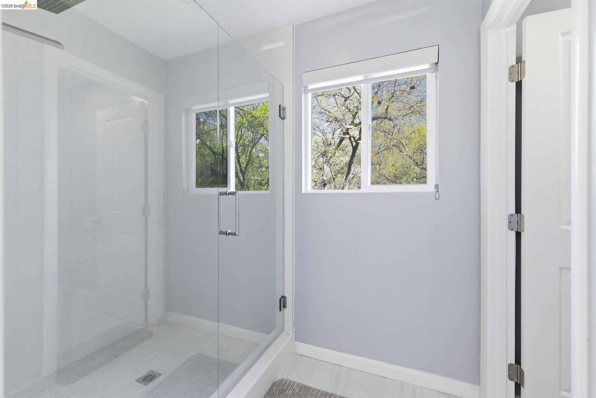 18389 Woodham Carne Road Sonora, CA 95370 - Photo 14 of 29 Bathroom featuring a shower stall and baseboards