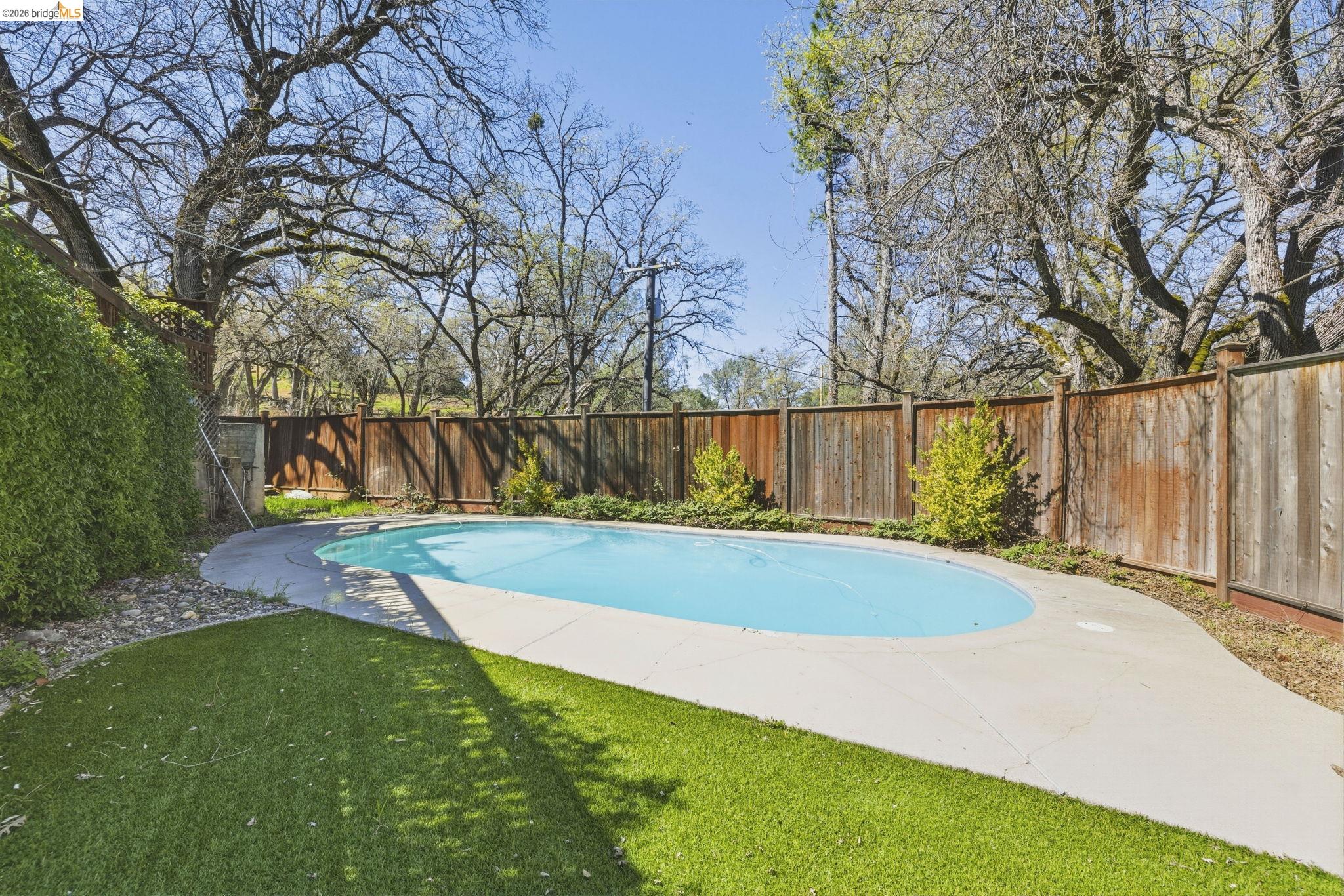 18389 Woodham Carne Road Sonora, CA 95370 - Photo 18 of 29 View of swimming pool featuring a fenced backyard and patio surround