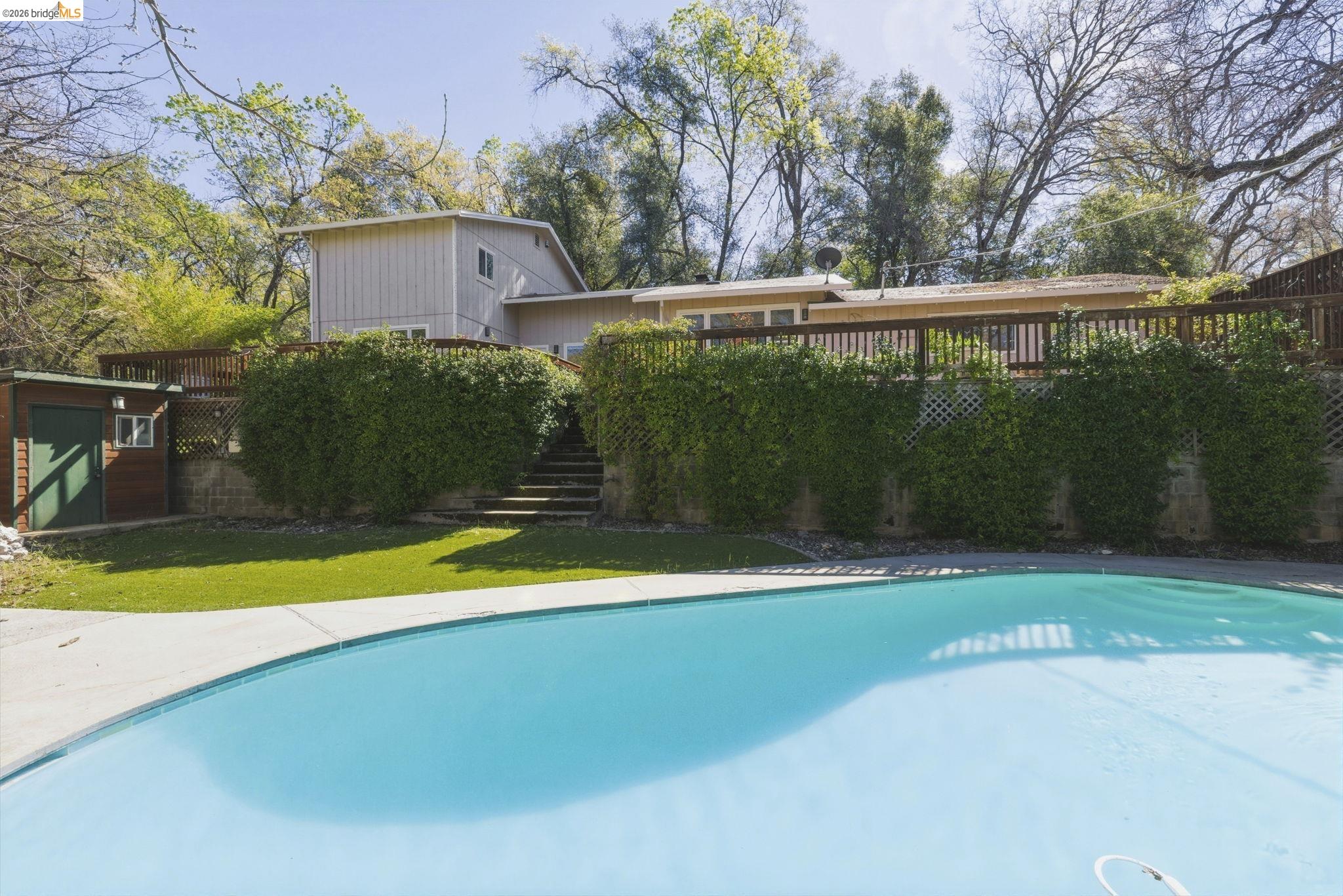 18389 Woodham Carne Road Sonora, CA 95370 - Photo 20 of 29 View of swimming pool with a wooden deck and stairway