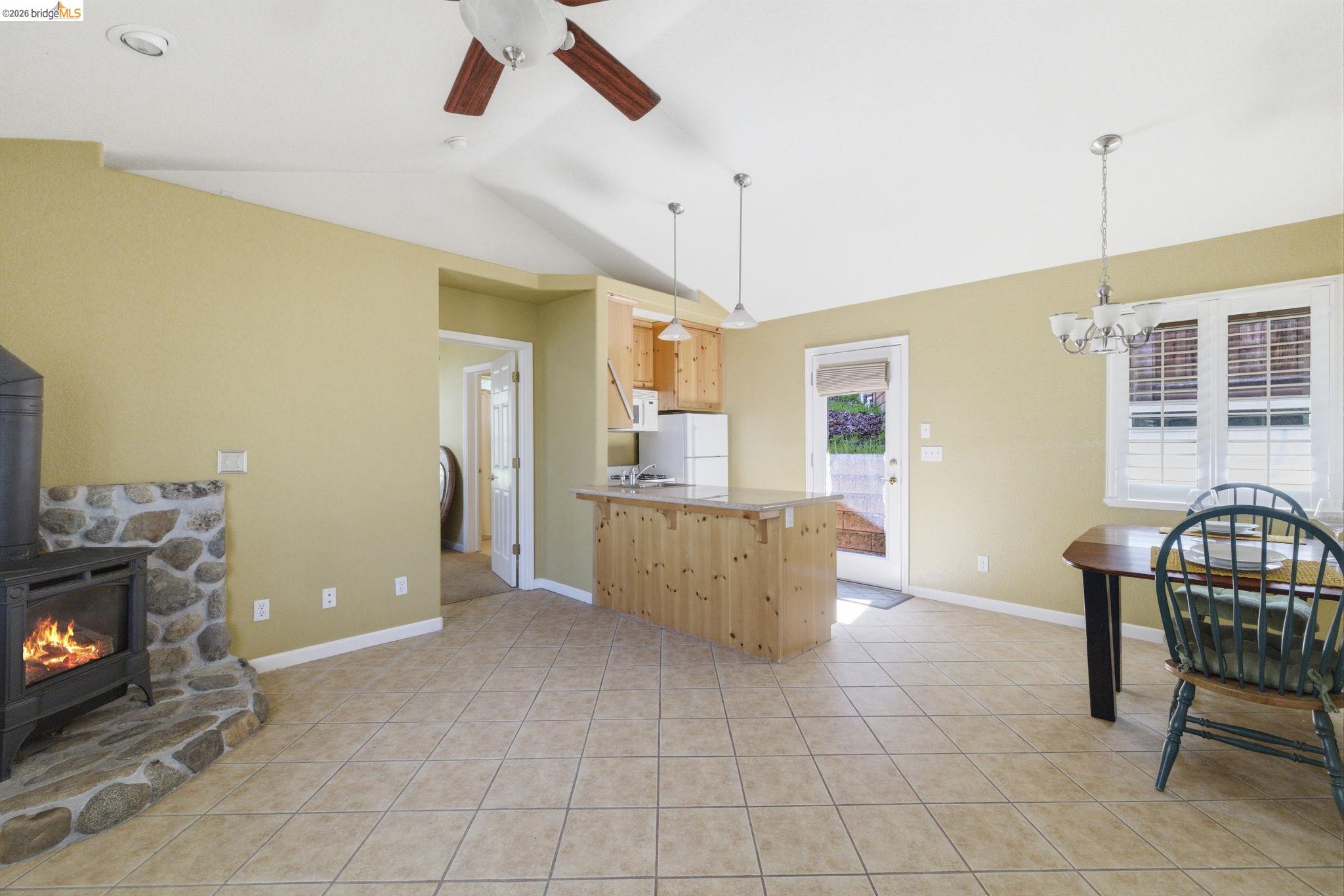 18389 Woodham Carne Road Sonora, CA 95370 - Photo 24 of 29 Kitchen with a peninsula, a ceiling fan, lofted ceiling, suspended lighting, and light wood finish cabinetry