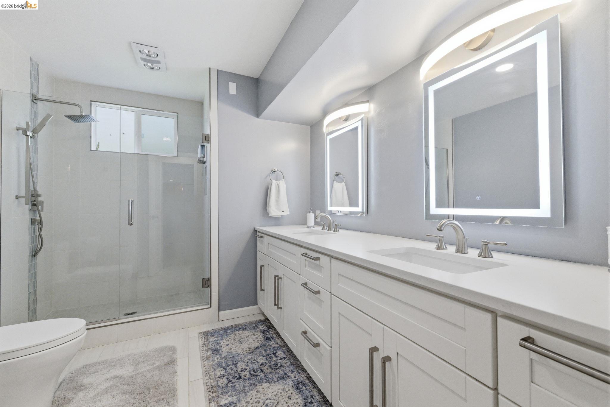 18389 Woodham Carne Road Sonora, CA 95370 - Photo 10 of 29 Full bathroom featuring double vanity, a shower stall, and light tile patterned floors