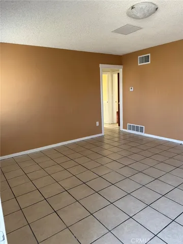 a view of an empty room and wooden floor