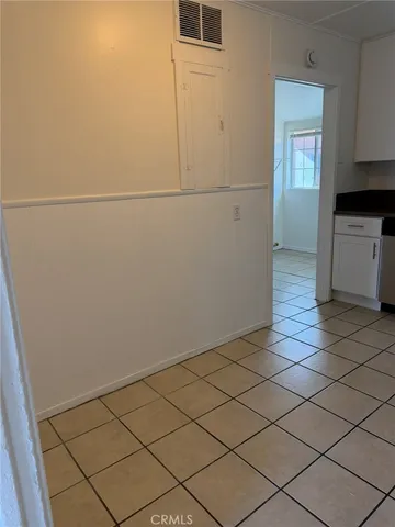 a view of a refrigerator in kitchen and utility room with window