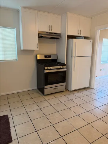 a kitchen with a cabinets and a stove top oven