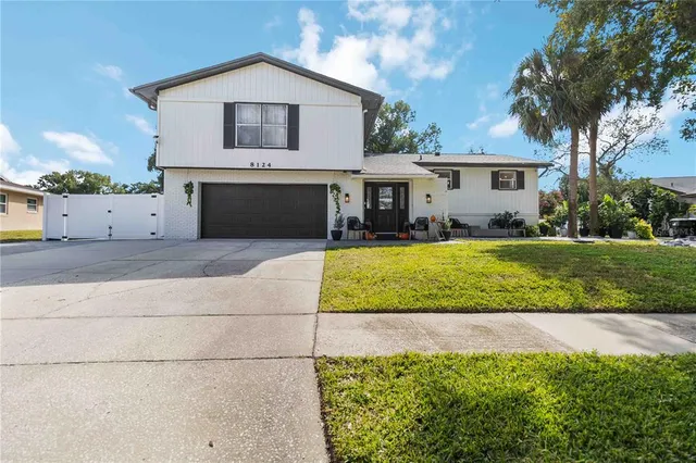 a view of house with yard and swimming pool