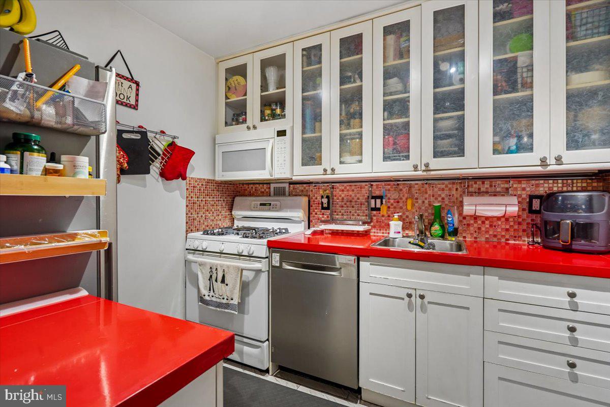 1260 21st Street Northwest, Unit 111 Washington, DC 20036 - Photo 7 of 33 Vibrant kitchen with bold red accents.