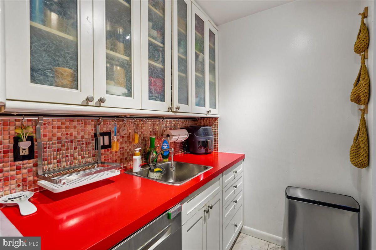 1260 21st Street Northwest, Unit 111 Washington, DC 20036 - Photo 9 of 33 Vibrant kitchen with bold red accents.