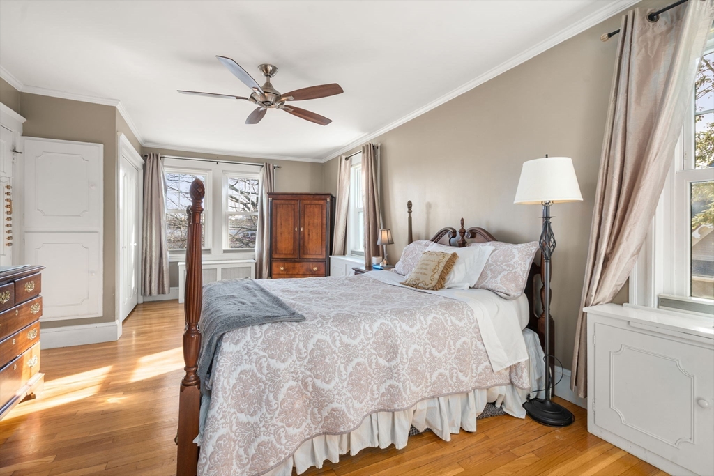 193 Garden Street Needham, MA 02492 - Photo 16 of 39 a bed room with a bed and a chandelier