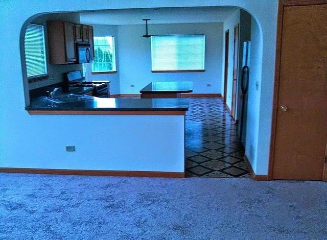 a bathroom with mirror sink and window