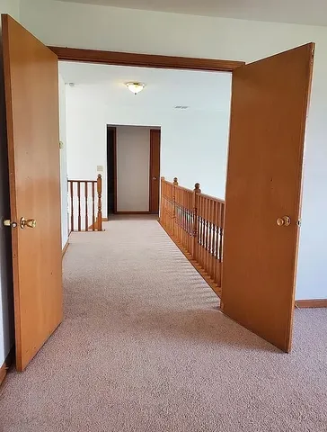 a view of a hallway with staircase