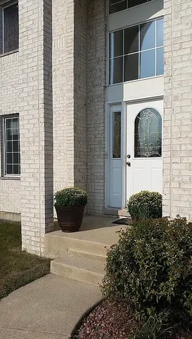 a view of a house with potted plants