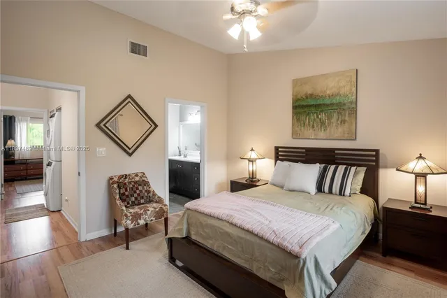 a spacious bedroom with a bed and a chandelier