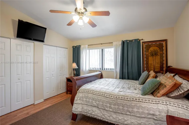 a bedroom with a large bed and a flat screen tv