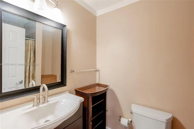 a bathroom with a sink a toilet and mirror