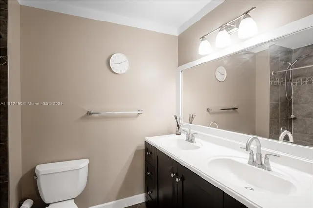 a bathroom with a toilet a sink and mirror