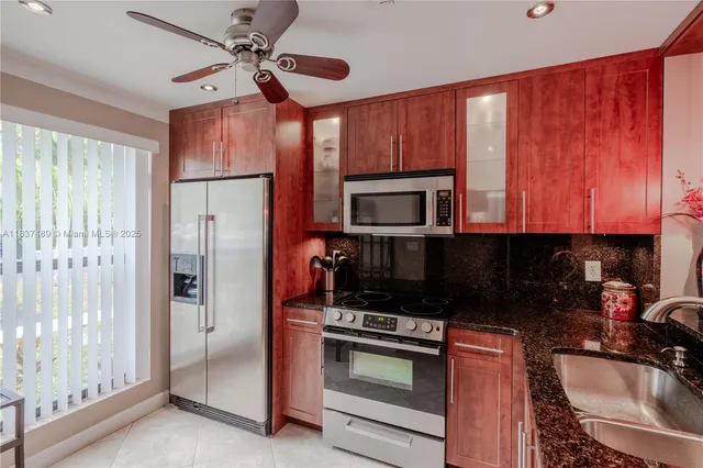 a kitchen with a sink a microwave and refrigerator