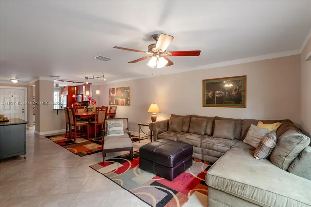 a living room with furniture gym equipment and a chandelier