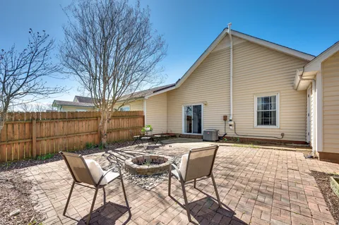 a view of a house with backyard and sitting area
