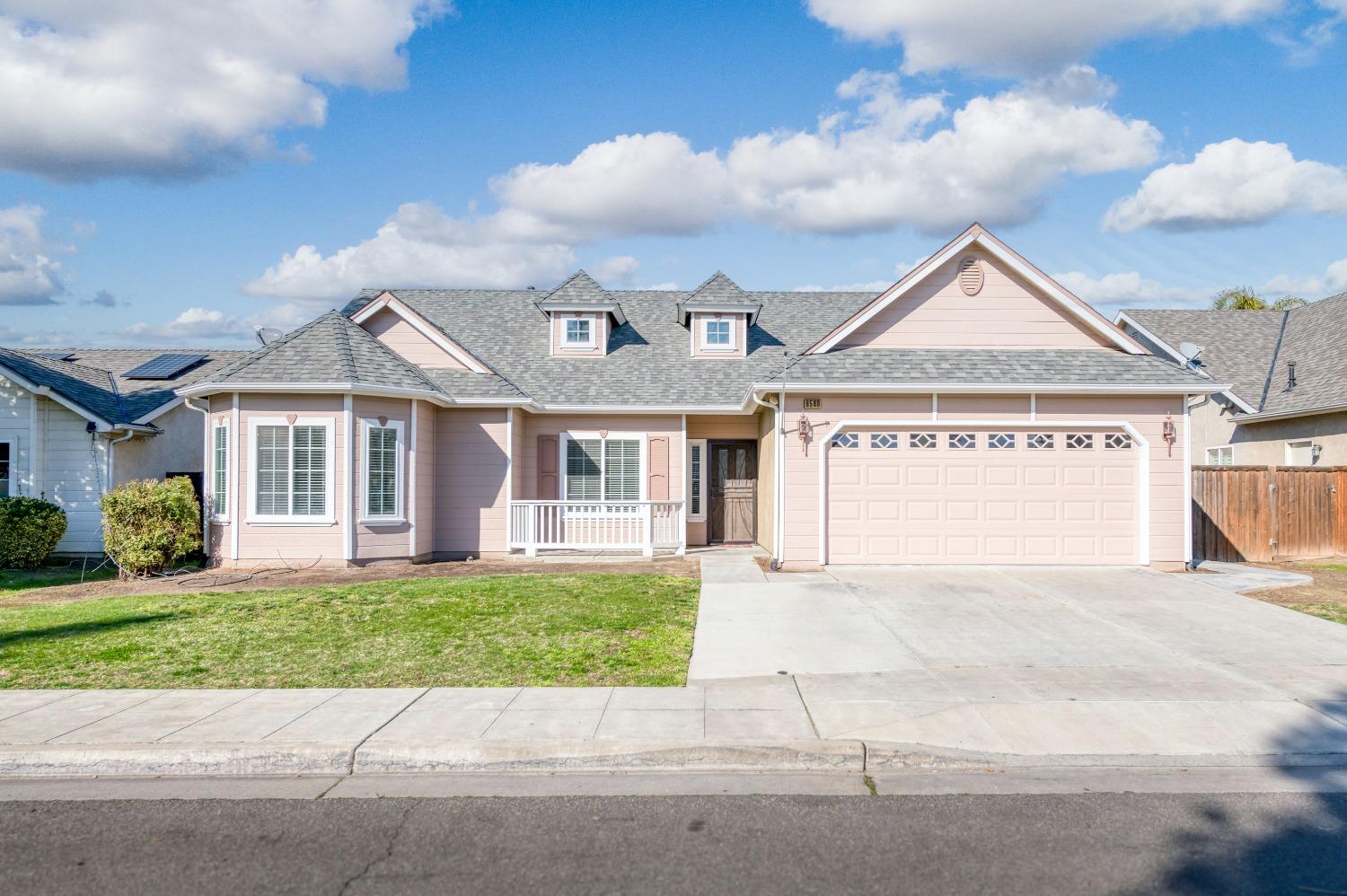 6580 East Raco Avenue Fresno, CA 93727 - Photo 1 of 30 a view of a house with a yard and potted plants