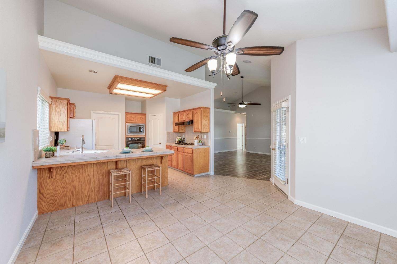 6580 East Raco Avenue Fresno, CA 93727 - Photo 11 of 30 a large white kitchen with a sink and dishwasher a refrigerator with white cabinets