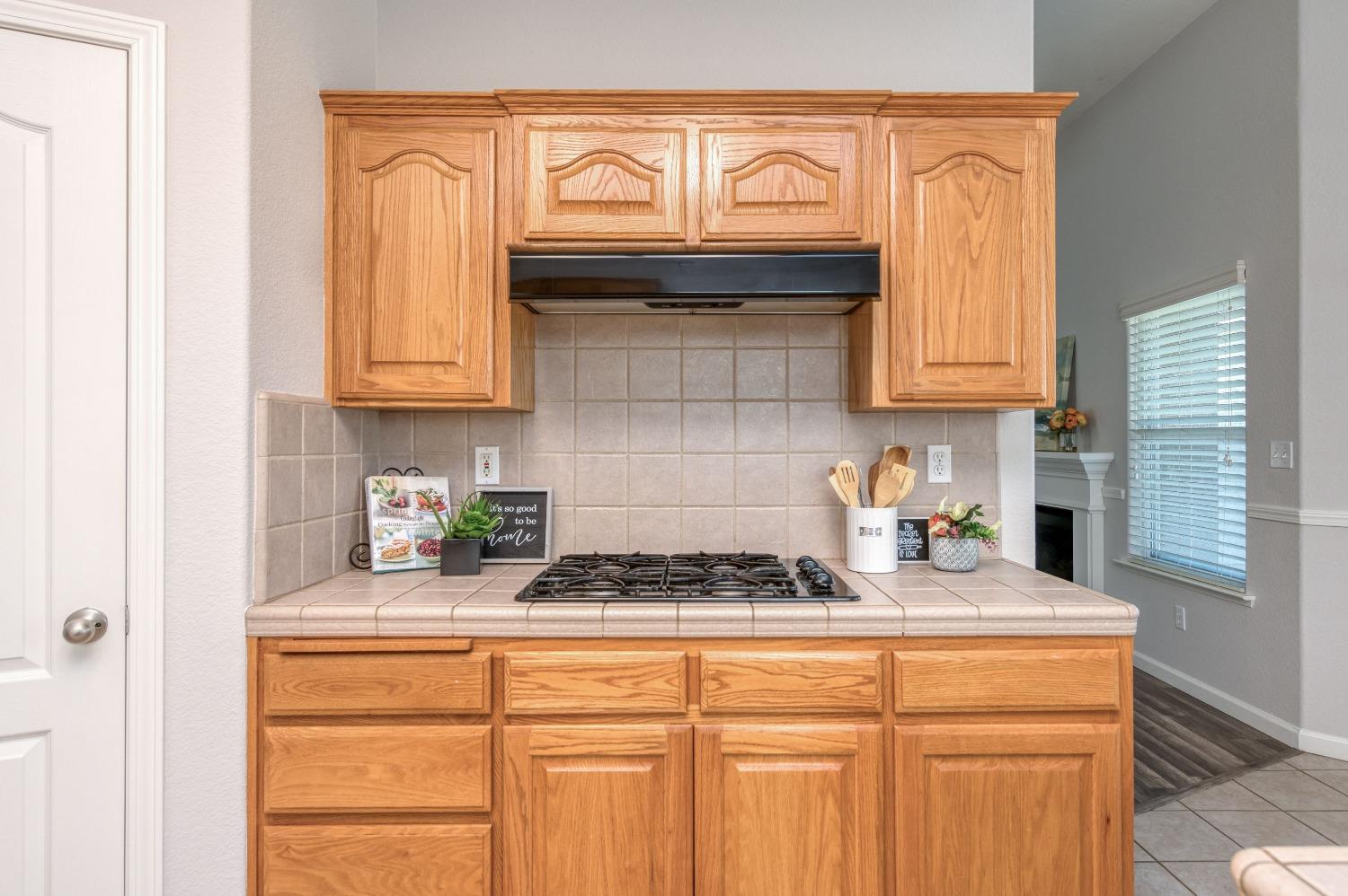 6580 East Raco Avenue Fresno, CA 93727 - Photo 15 of 30 a kitchen with granite countertop cabinets and a stove top oven