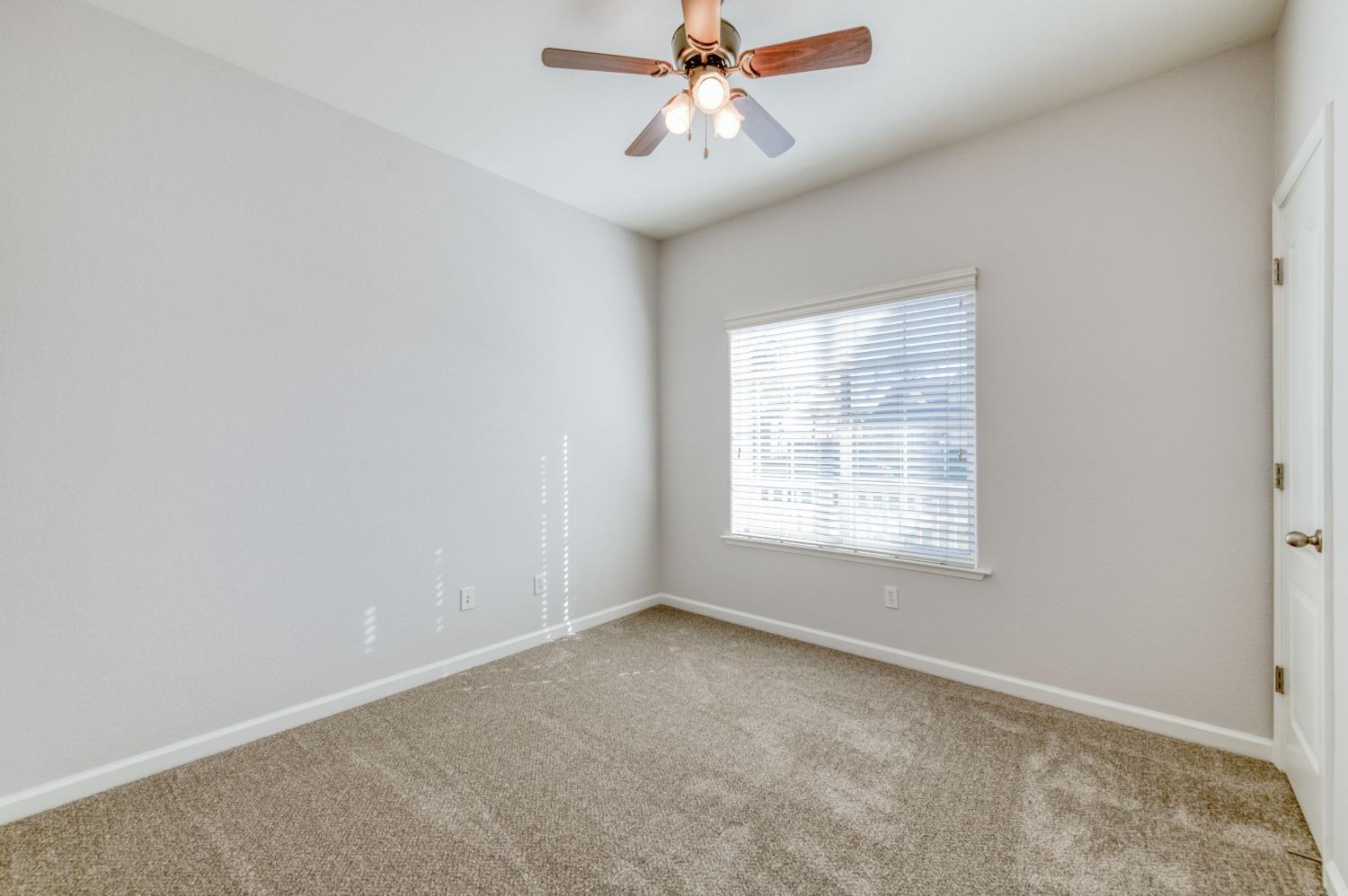 6580 East Raco Avenue Fresno, CA 93727 - Photo 16 of 30 an empty room with a window and a fan