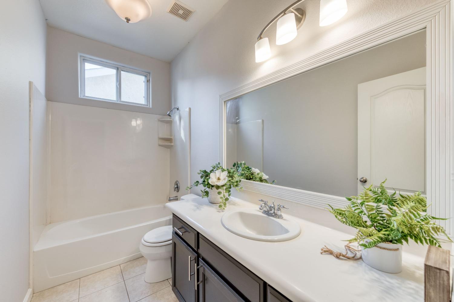 6580 East Raco Avenue Fresno, CA 93727 - Photo 18 of 30 a bathroom with a sink toilet and shower