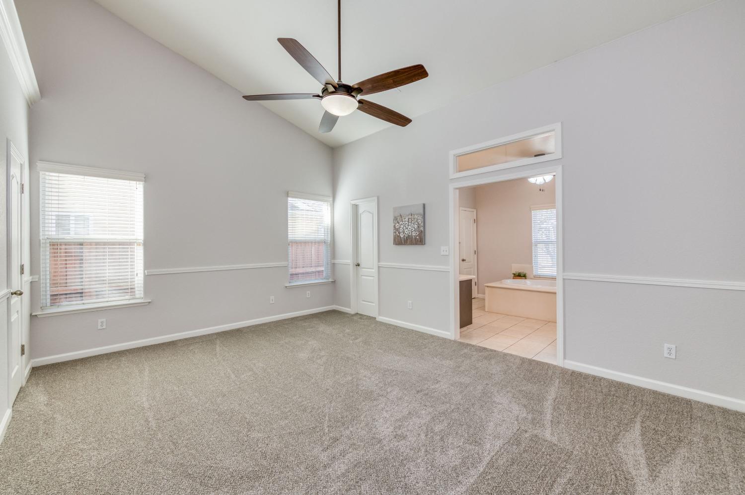 6580 East Raco Avenue Fresno, CA 93727 - Photo 19 of 30 an empty room with fan and windows
