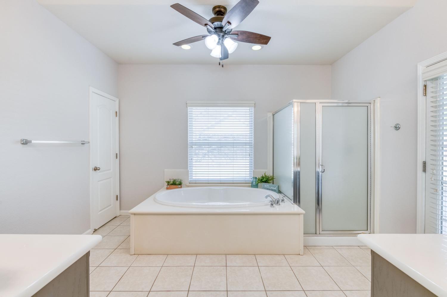 6580 East Raco Avenue Fresno, CA 93727 - Photo 21 of 30 a spacious bathroom with a tub shower and sink