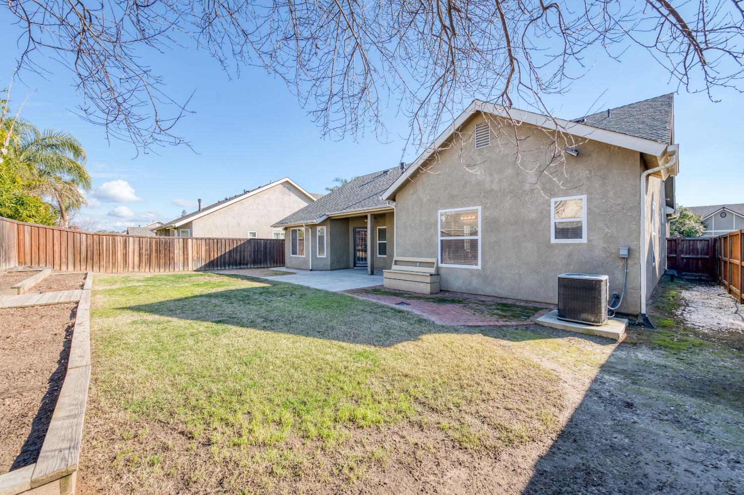 6580 East Raco Avenue Fresno, CA 93727 - Photo 26 of 30 a view of a house with a yard