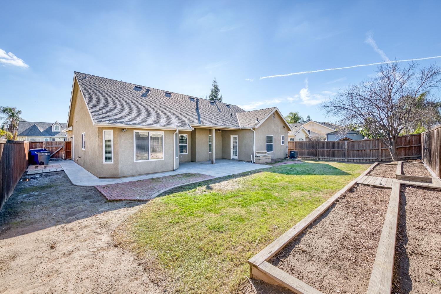 6580 East Raco Avenue Fresno, CA 93727 - Photo 27 of 30 a view of a house with a backyard