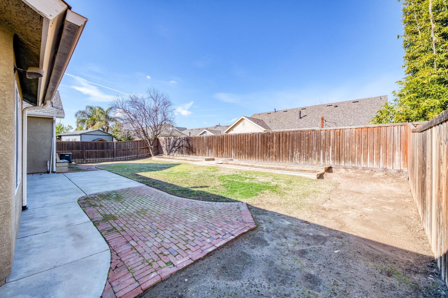 6580 East Raco Avenue Fresno, CA 93727 - Photo 28 of 30 a view of a backyard with a tree
