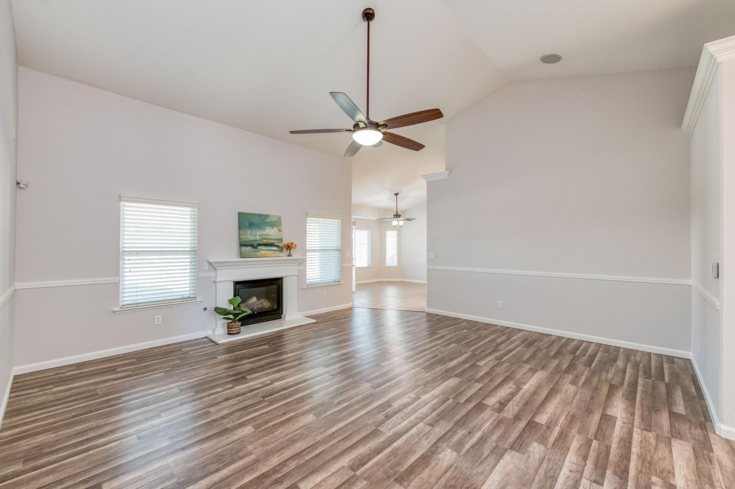 6580 East Raco Avenue Fresno, CA 93727 - Photo 5 of 30 a view of livingroom with hardwood floor fireplace and window