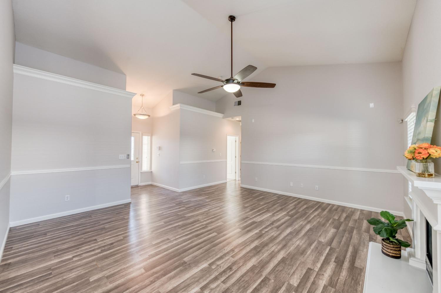 6580 East Raco Avenue Fresno, CA 93727 - Photo 7 of 30 a view of an empty room with a window and wooden floor