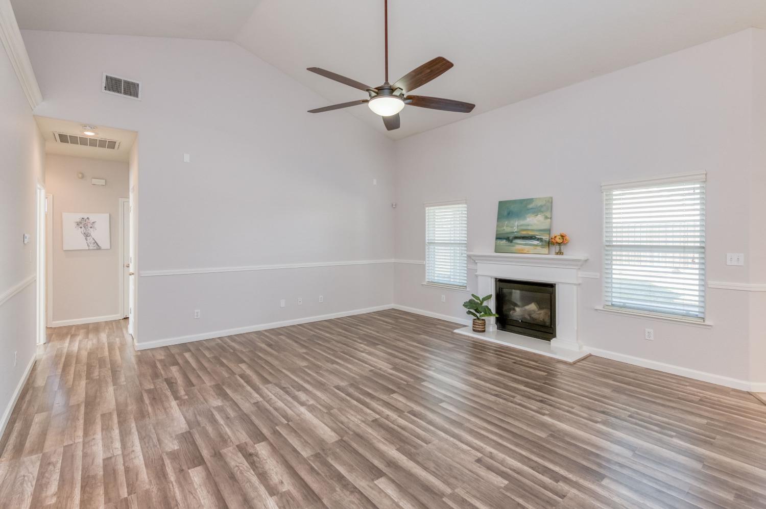 6580 East Raco Avenue Fresno, CA 93727 - Photo 8 of 30 a view of empty room with wooden floor and fan