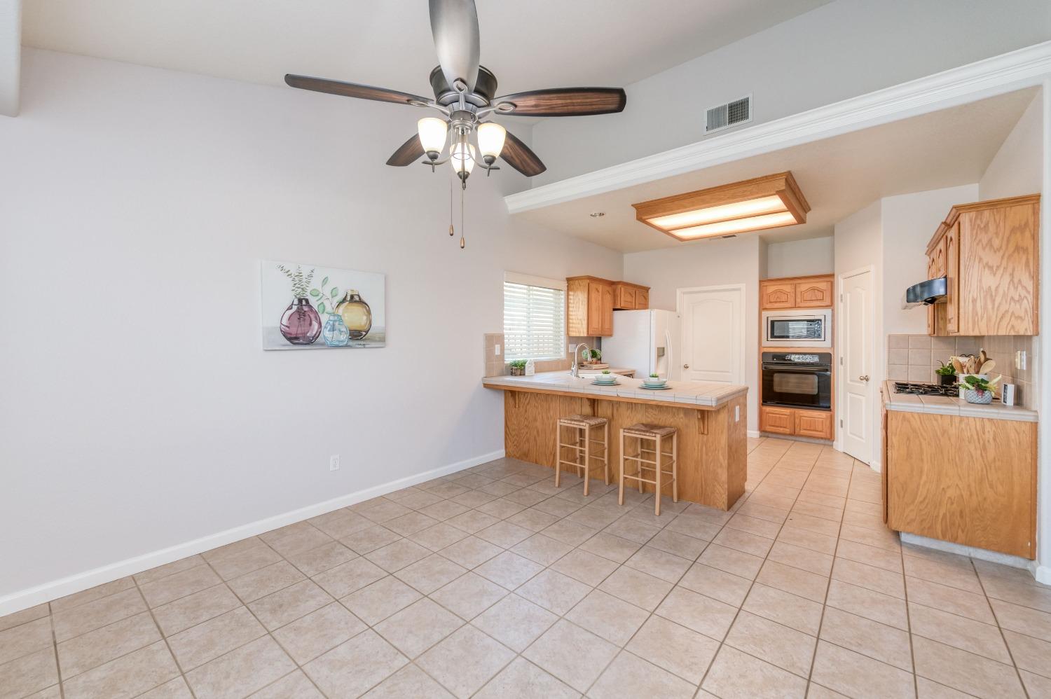 6580 East Raco Avenue Fresno, CA 93727 - Photo 10 of 30 a view of kitchen with cabinets and window