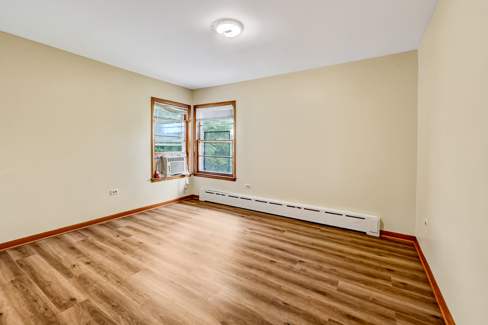 219 79th Street Burr Ridge, IL 60527 - Photo 15 of 28 an empty room with wooden floor and windows