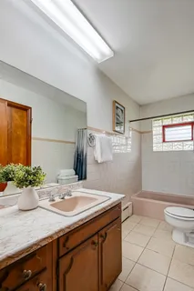 a view of a green field with trees in the background