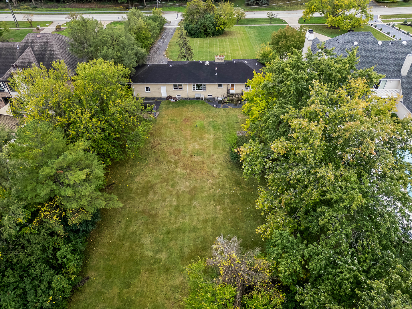219 79th Street Burr Ridge, IL 60527 - Photo 26 of 28 an aerial view of a house with a yard lake and outdoor seating